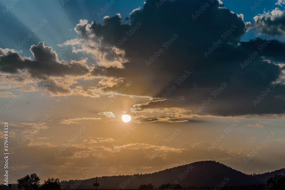 Naklejka premium Sunset Williams AZ with storm clould.