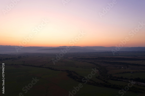 Aerial view from the drone. Stunning mountain and countryside view shot from a drone in the morning at dawn. Beautiful landscape of sunrise in the mountains