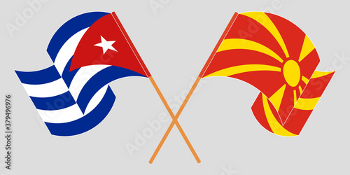Crossed and waving flags of North Macedonia and Cuba