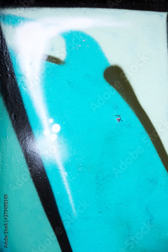 Abstract creative background of chaotic strokes of old cracked paint on concrete wall. Old surface with traces of paint, weathered, scratches and cracks for design