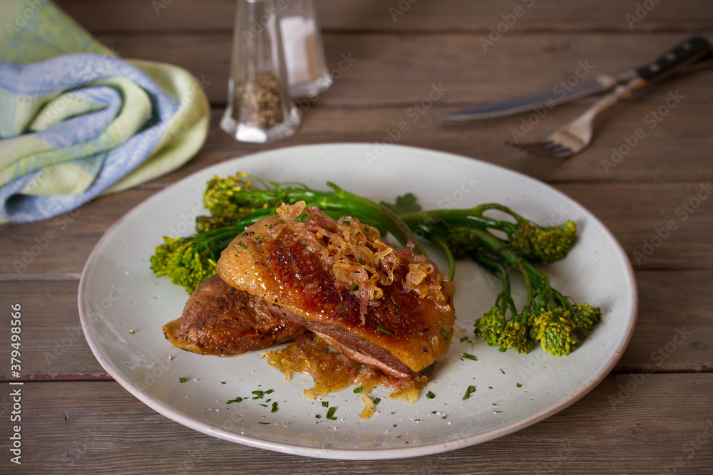 Roast duck breast fillets with vegetables on plate. vertical image Roast duck breast fillets with vegetables on plate. vertical image