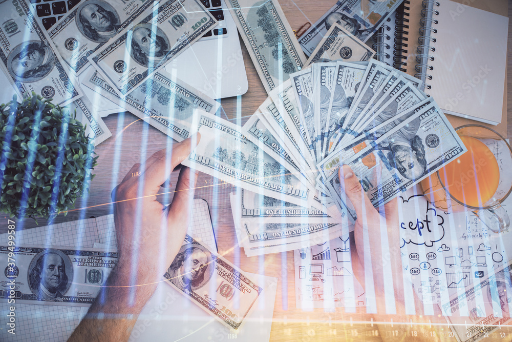 Multi exposure of financial graph drawing hologram and USA dollars bills and man hands. Analysis concept. Multi exposure of financial graph drawing hologram and USA dollars bills and man hands. Analysis concept.