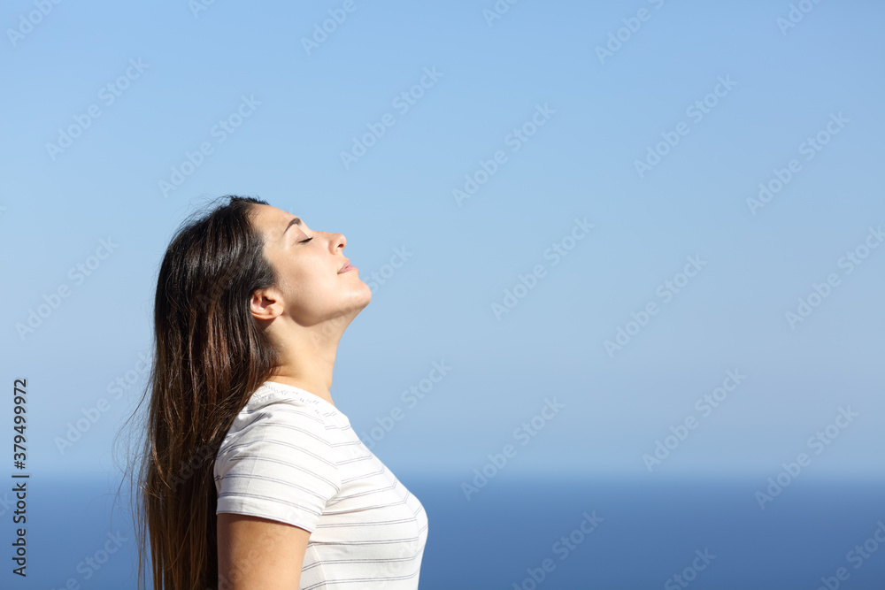 Woman profile breathing fresh air on the beach Woman profile breathing fresh air on the beach