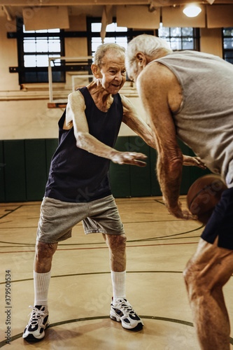 Elderly men playing basketball
