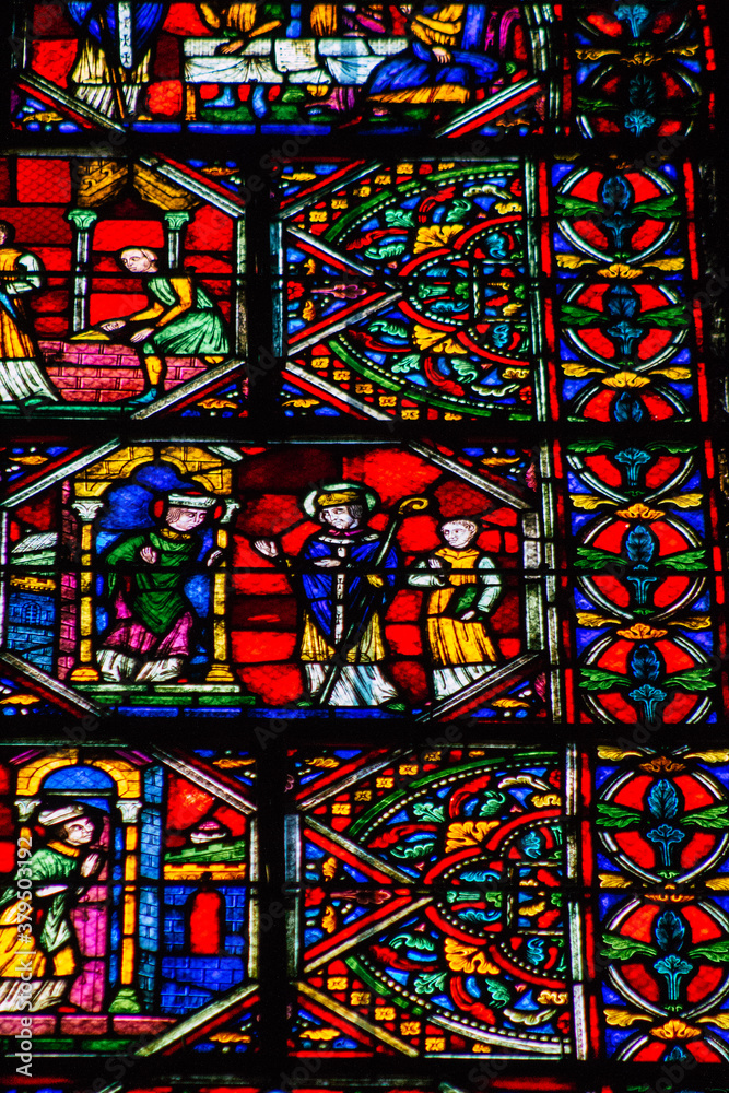 View of stained glass windows inside the Basilica of Saint-Remi, a medieval abbey church in Reims, a historical monument in the Grand Est region of France  
