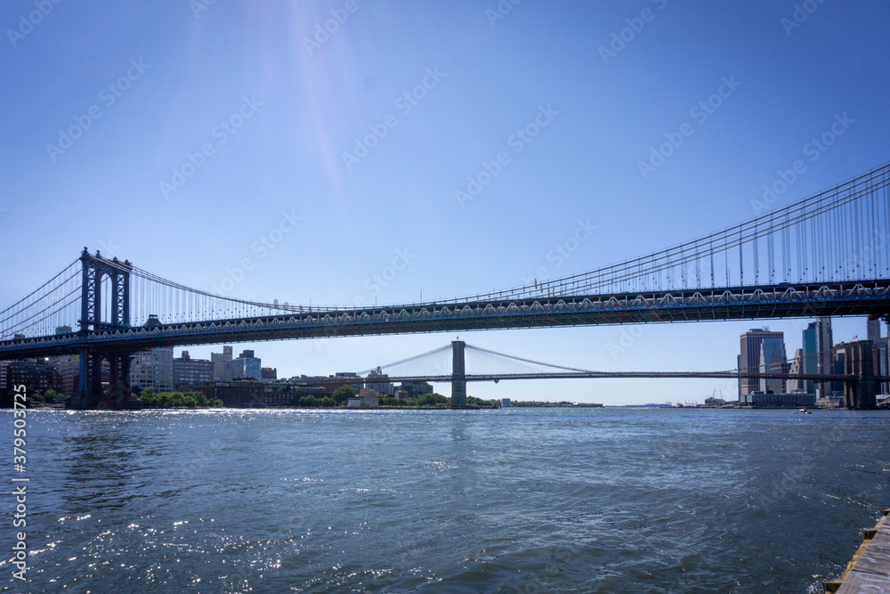 New York,NY / USA - September 19 2020: Two Bridges: Brooklyn Bridge and Manhattan Bridge over East River in downtown Manhattan, seaport district.