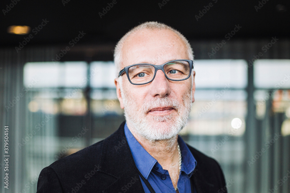 Mature businessman standing at workplace Mature businessman standing at workplace