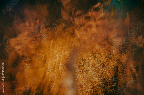 Multiple exposure of young male and female friends at illuminated restaurant photo