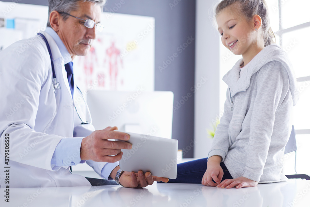 Portrait of a cute little girl and her doctor at hospital Portrait of a cute little girl and her doctor at hospital