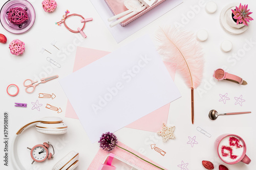 Flat lay desk composition in pastel pink tone