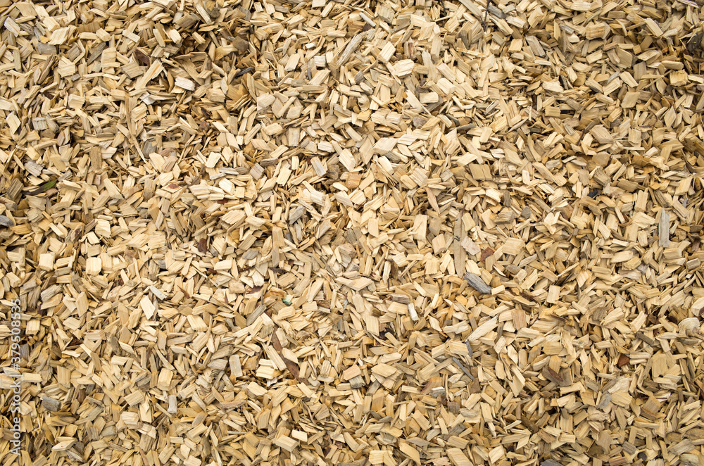 View from the top of the background texture of light color wooden chips/playground mulch covered the ground. View from the top of the background texture of light color wooden chips/playground mulch covered the ground.