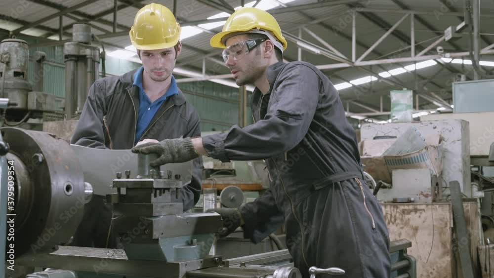 Team engineer working looking report on blueprint, two man planning project, technician inspect and fix machine, entrepreneur management and control in factory, industrial and construction concept.