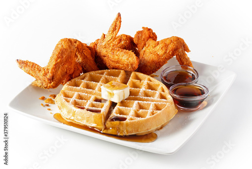 Large waffle with crispy fried chicken wings on white background with copy space photo