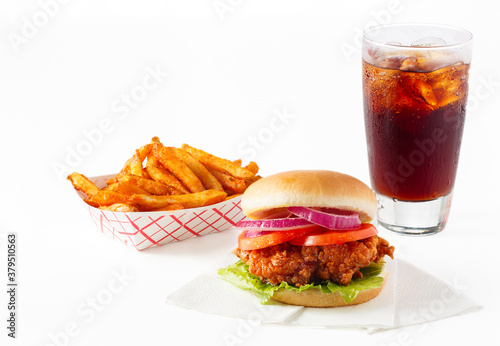 Fried chicken sandwich with fries and cola on white background with copy space