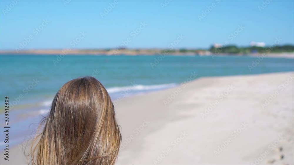 Cute little girl at beach during summer vacation