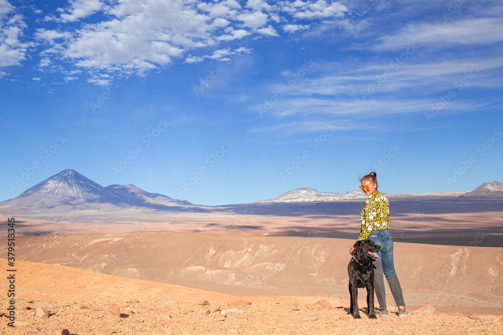 woman with her dog in a desert landscape