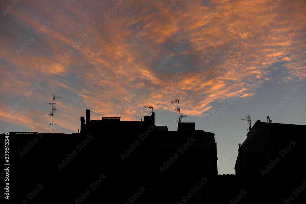 Building silhouette with orange sunlight in the clouds, municipality of Pamplona, capital of the province of Navarra, Spain