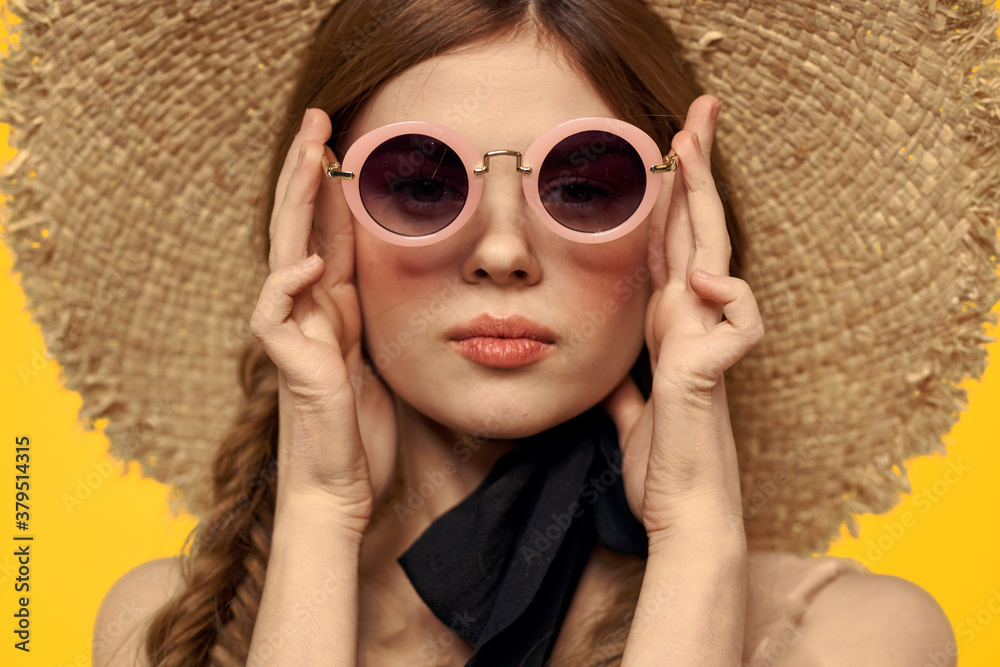 Romantic woman in hat having fun on a yellow background and sunglasses black ribbon model portrait
