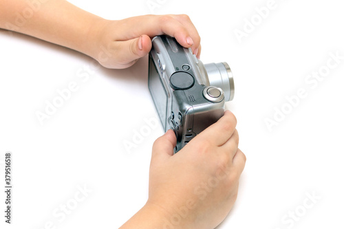 Kid hands hold digital old camera soap box on isolated white background, kid's hobby concept, learning journalism, paparating, photographing, child learning to photograph