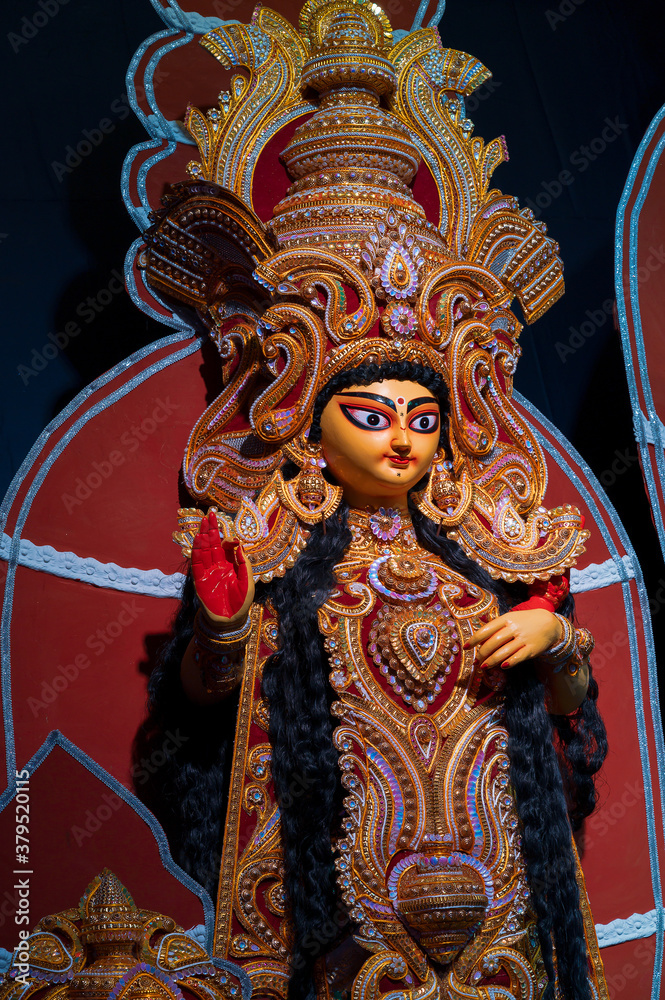 Fototapeta premium Goddess Laxmi, Durga Puja festival at night. Shot under colored light at Howrah, West Bengal, India.