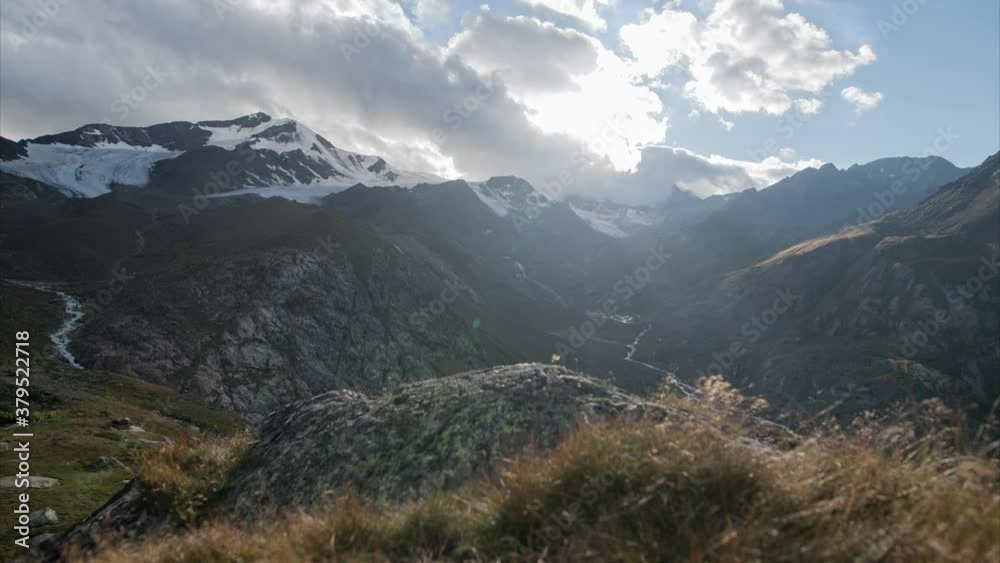 Timelapse in the mountains of the Italian Alps on a slider with moving clouds during sunset Timelapse in the mountains of the Italian Alps on a slider with moving clouds during sunset