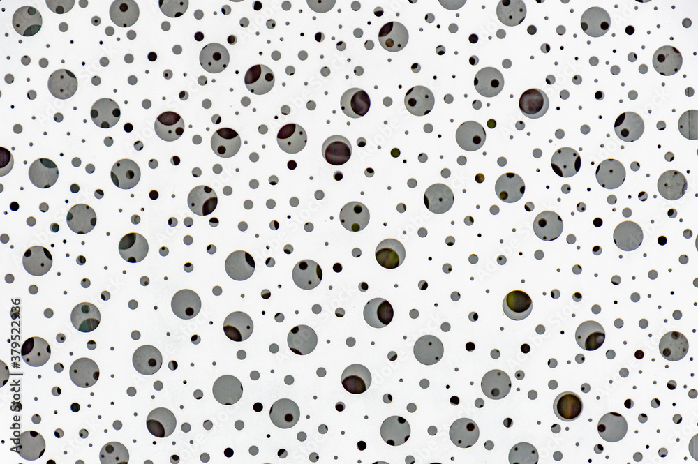 Textured background, white iron plate with holes