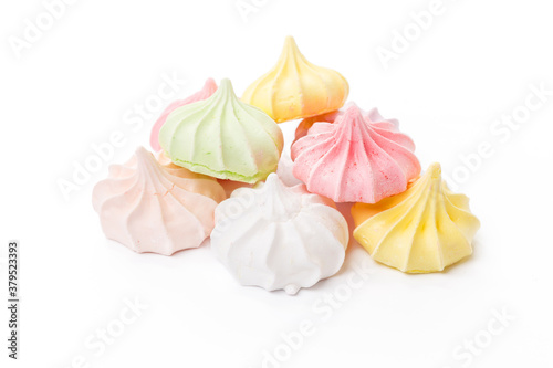 Pile of colorful meringue cookies isolated on white photo