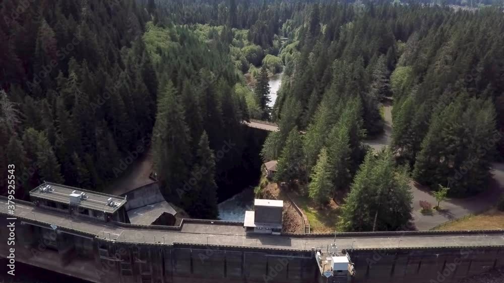 Revealing Shot Of The Wynoochee Dam In Washington With Extreme Water Cascade Flowing - aerial drone Revealing Shot Of The Wynoochee Dam In Washington With Extreme Water Cascade Flowing - aerial drone
