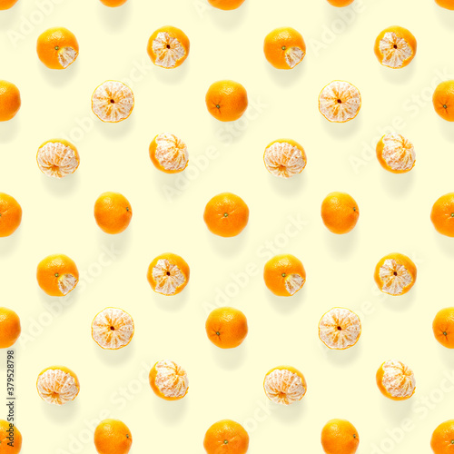 Fresh mandarine Seamles pattern. Ripe fruit tangerines seamless pattern. Fresh citrus isolated on yellow background pattern. Flat lay of Clementine.