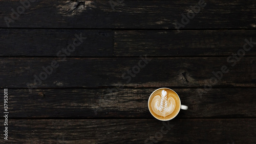 a cup of latte art coffee on wooden background 