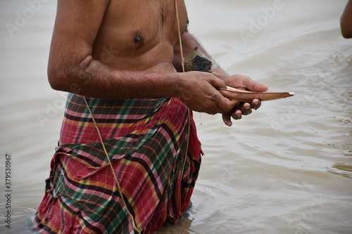 Tarpan is being performed by Indian hindu devotees on the banks of the holy river Ganga in Kolkata, India. In Hindu mythology this day is also called Mahalaya. photo