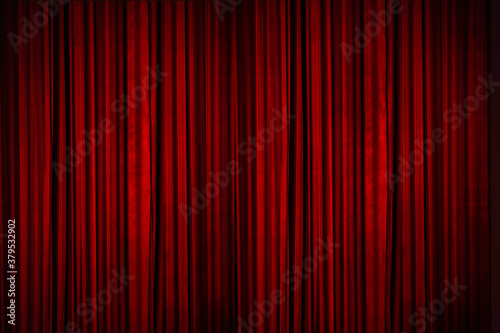 Beautiful red curtains of the stage lit with stage lights, moments before the curtains went up to reveal the stage