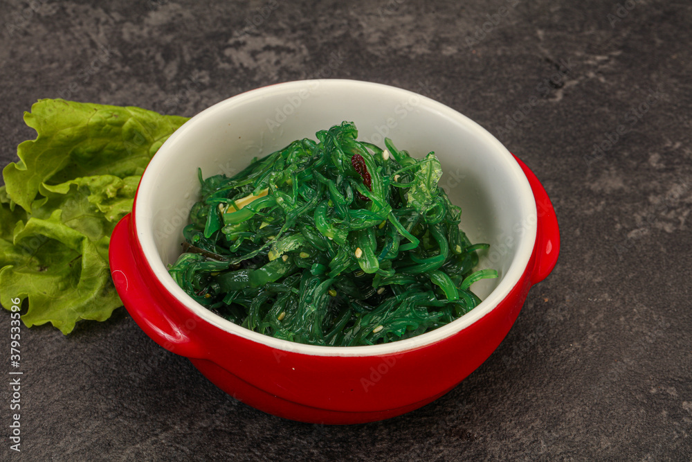 Green Chuka Seaweed Salad Isolated on White Background Top View. Wakame Sea Kelp Salat Green Chuka Seaweed Salad Isolated on White Background Top View. Wakame Sea Kelp Salat