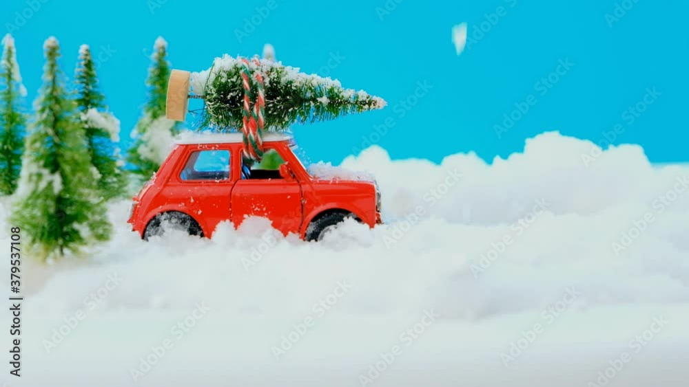 Red toy car with a christmas tree on the roof