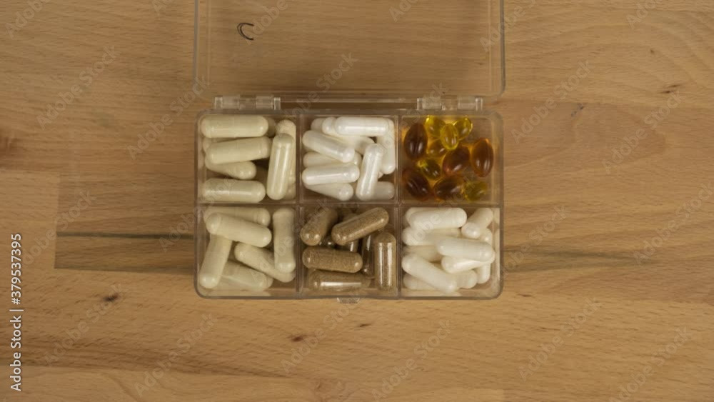 Stop motion of filling a pill box with vitamins Stop motion of filling a pill box with vitamins