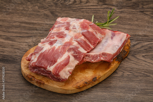 Raw pork ribs served rosemary