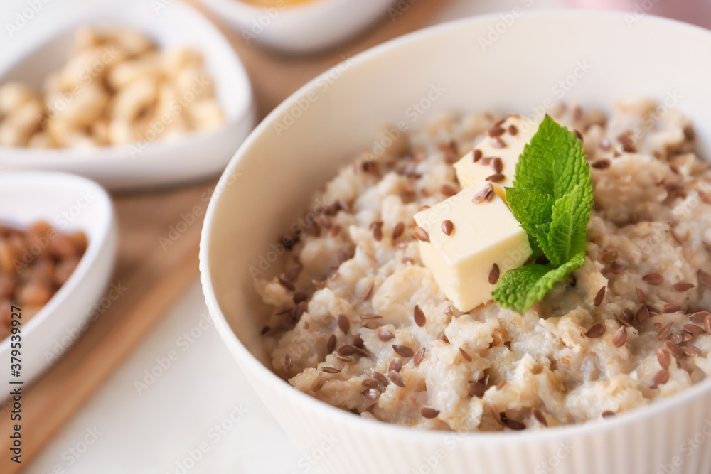 Bowl with tasty sweet oatmeal on table, closeup Bowl with tasty sweet oatmeal on table, closeup
