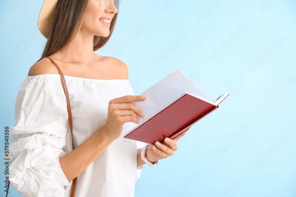 Beautiful young woman with book on color background Beautiful young woman with book on color background