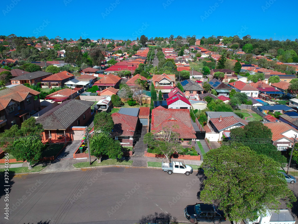 Fototapeta premium Panoramic Aerial Drone view of Suburban Sydney housing, roof tops, the streets and the parks