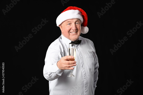 Elderly man with champagne ...