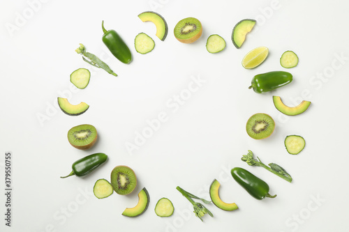 Green vegetables and fruits on white background