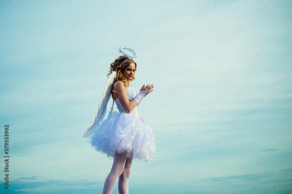 Charming curly little girl in white dress and wings - angel cupid girl. Enjoying magic moment. Teenager Cherub Cupid. Heaven. Charming curly little girl in white dress and wings - angel cupid girl. Enjoying magic moment. Teenager Cherub Cupid. Heaven.