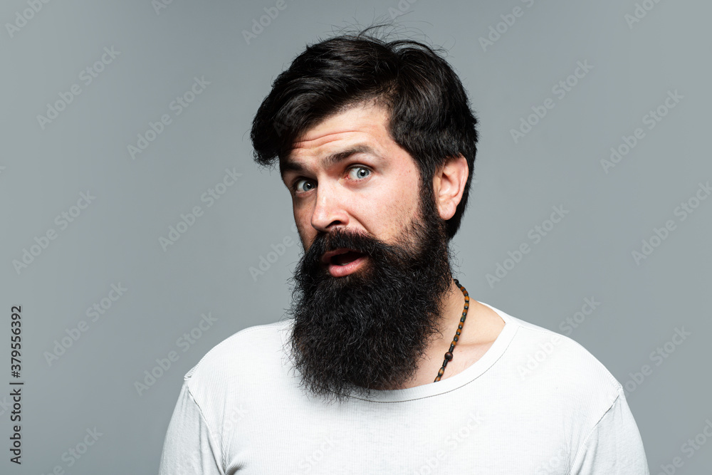 Surprised handsome man. Barber with long beard and moustache in barbershop. Bearded hipster. Surprised handsome man. Barber with long beard and moustache in barbershop. Bearded hipster.
