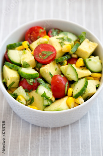 Fresh Avocado Tomato Salad in a bowl, side view.