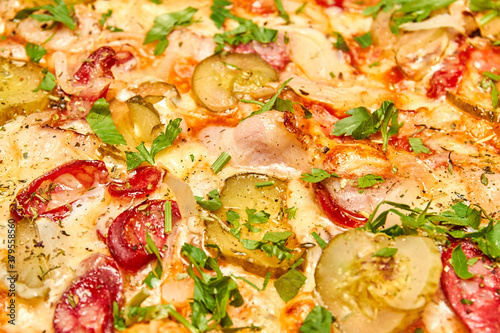 Pizza filling with pickles, bacon, sausages and cheese. Close-up, selective focus