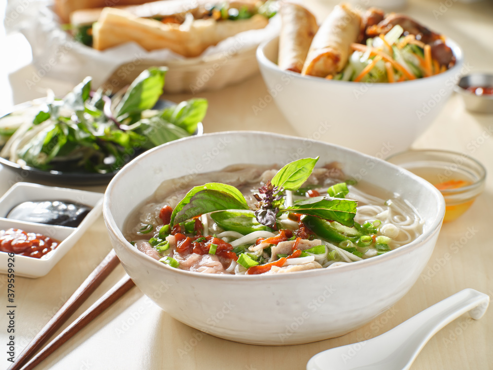 vietnamamese meal with beef pho bo soup accompanied by hoisin sauce and sriracha vietnamamese meal with beef pho bo soup accompanied by hoisin sauce and sriracha