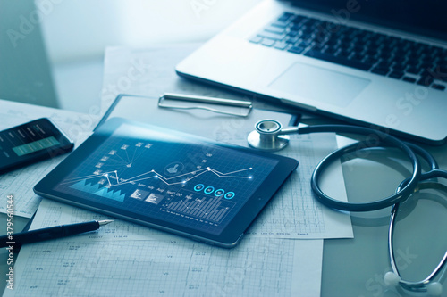 Healthcare business concept, Medical examination and graph data growth of business on tablet with doctor's health report clipboard on background. photo