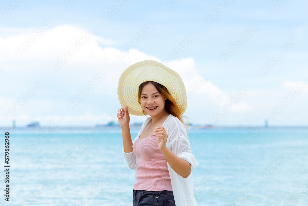 Asian women playing in the sea at the beach. Beautiful women enjoying their holidays on a beach in Thailand.