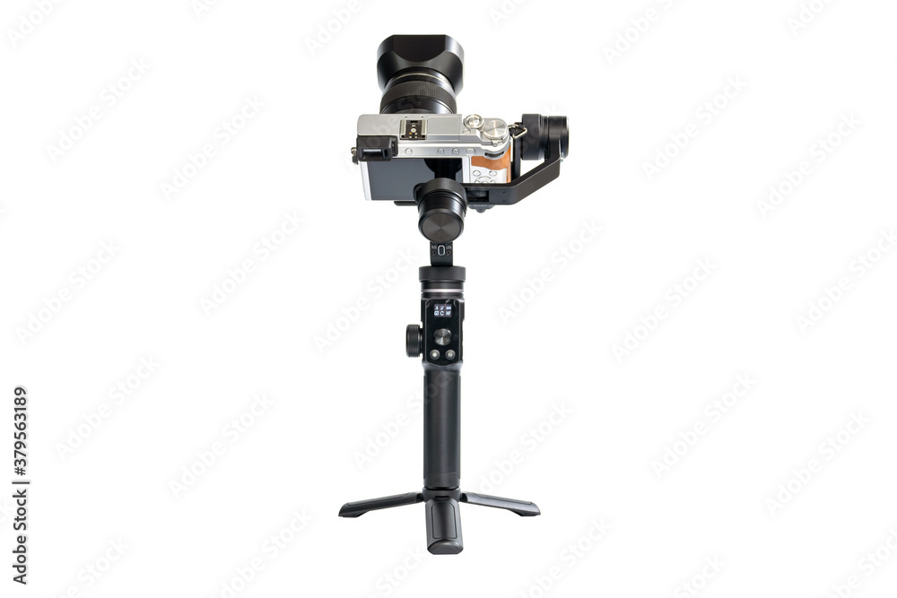 DSLR camera is mounted on a 3-axis motor stabilizer for smooth video recording isolated on white background. DSLR camera is mounted on a 3-axis motor stabilizer for smooth video recording isolated on white background.