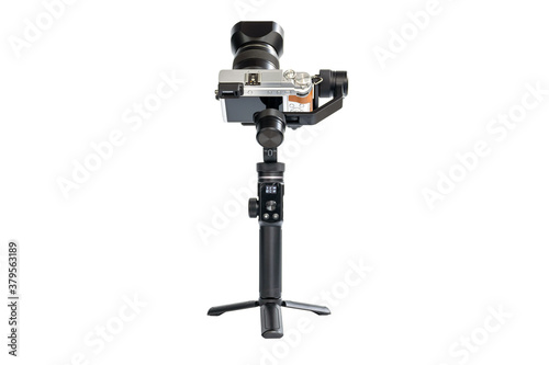 DSLR camera is mounted on a 3-axis motor stabilizer for smooth video recording isolated on white background.